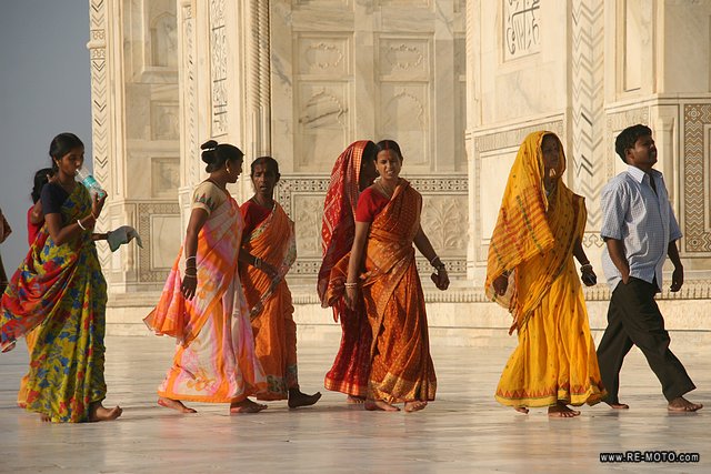 The coloured dresses stand out against the Taj. 
